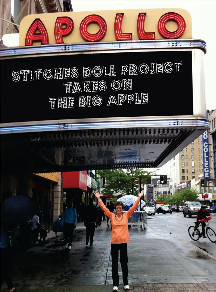 Kathy beneath the Apollo marquee, which reads Stitches Doll Project Takes on the Big Apple