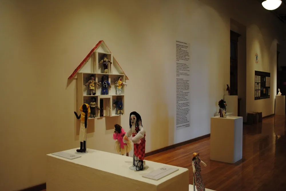 Stitches dolls arranged on display stands in an art exhibition